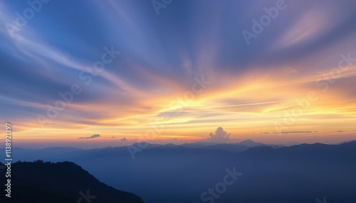 a view of a mountain range with a sunset in the background