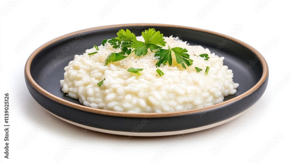 Creamy risotto garnished with herbs on a black plate. Creamy risotto garnished with herbs on a black plate.