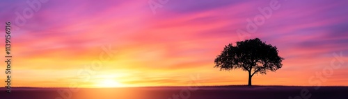 Silhouetted tree against a vibrant sunset sky with colorful clouds.