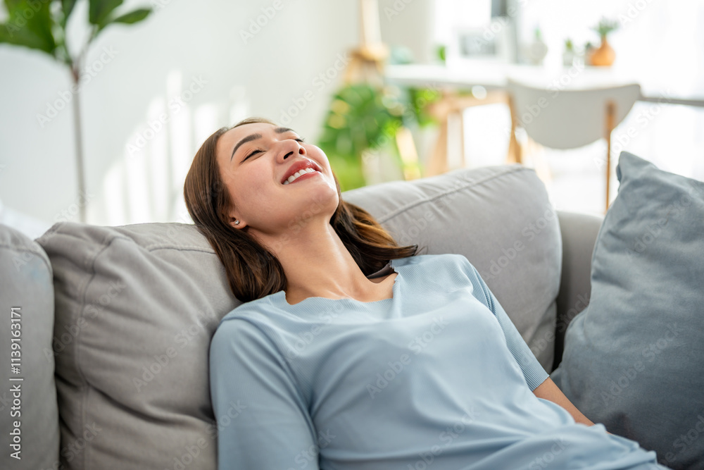 Asian beautiful girl lying down on comfort sofa in living room at home. Asian beautiful girl lying down on comfort sofa in living room at home.