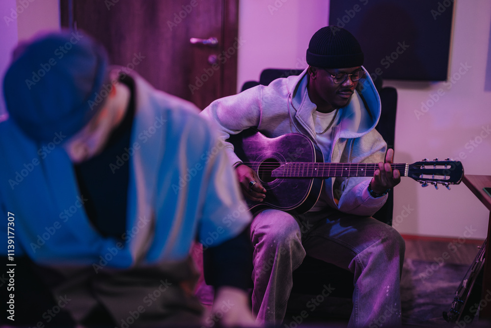 Obraz premium Two musicians of diverse backgrounds collaborate in a recording studio, creating beautiful music together. The warm, inviting atmosphere enhances their creative synergy and musical performance.