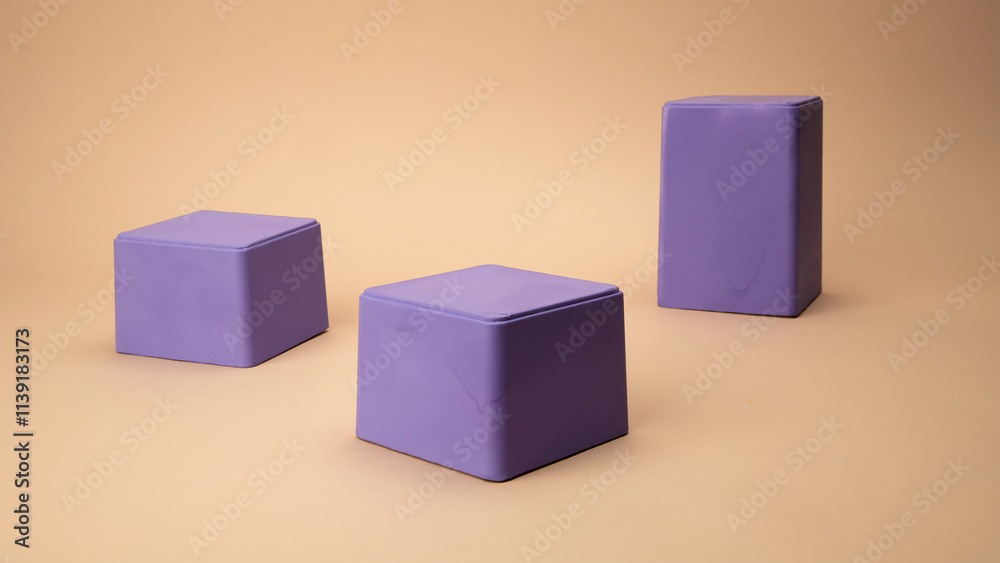 Purple boxes of different sizes lying on a beige background Purple boxes of different sizes lying on a beige background