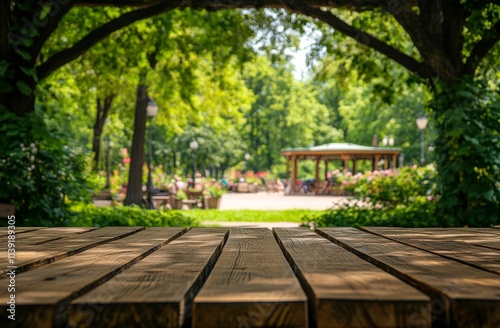 Empty wooden picnic table in lush park.