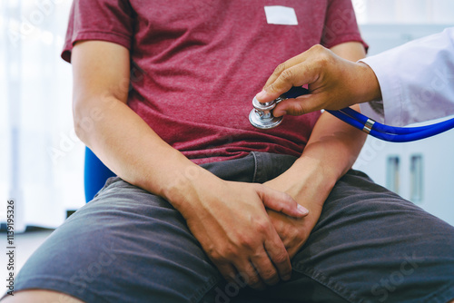 A man suffering from urinary tract infections visits a doctor at the examination table in a hospital.symptoms, discusses benign prostatic hyperplasia (BPH), and provides advice and treatment photo