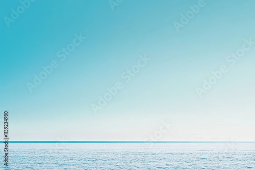 Fototapeta Naklejka Na Ścianę i Meble -  Calm ocean meeting a serene, clear sky.