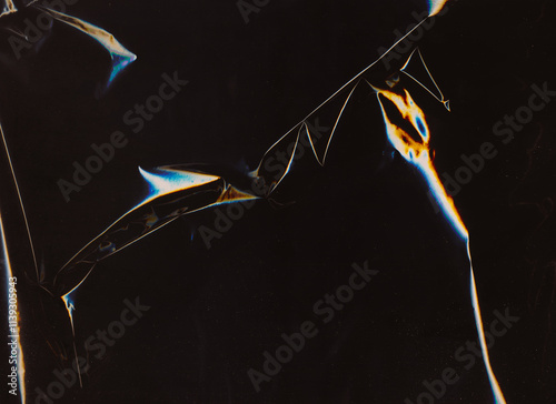 Distressed foil. Old film overlay. Blue orange white color light flare dust scratch defect uneven wrinkled worn retro texture dark black illustration art abstract background.