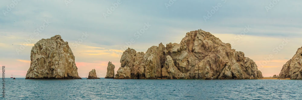 Fototapeta premium A rocky shoreline with a calm ocean in the background