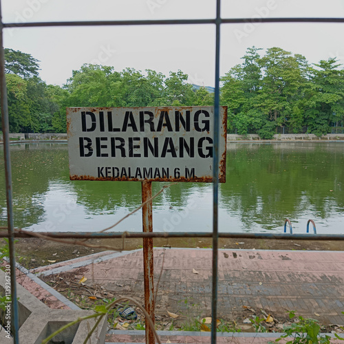 No swimming sign posted at the edge of the pool