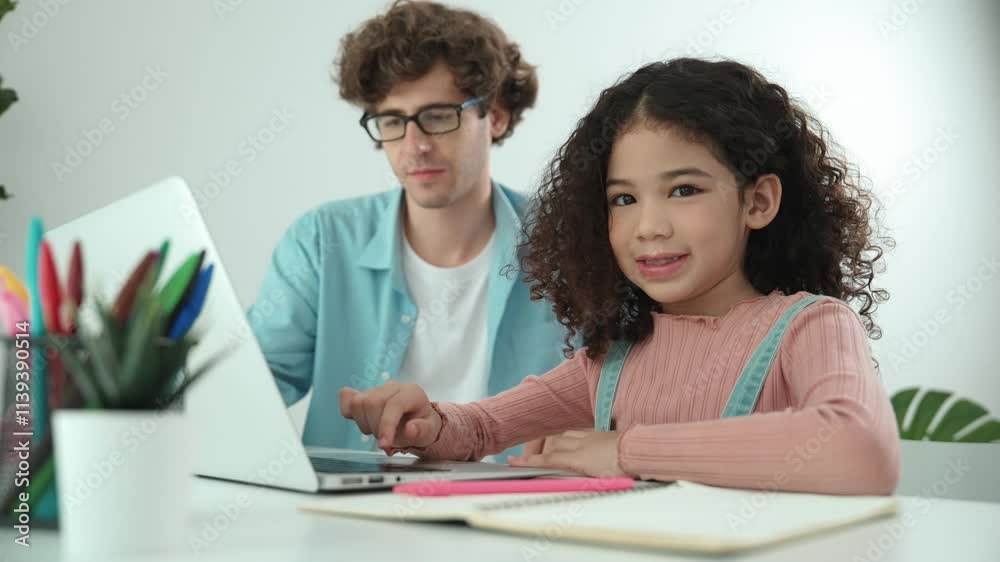 American student looking at camera while working on laptop with dad sitting and looking at laptop screen to check engineering code. Happy school girl smiling while study about generate ai. Pedagogy. American student looking at camera while working on laptop with dad sitting and looking at laptop screen to check engineering code. Happy school girl smiling while study about generate ai. Pedagogy.