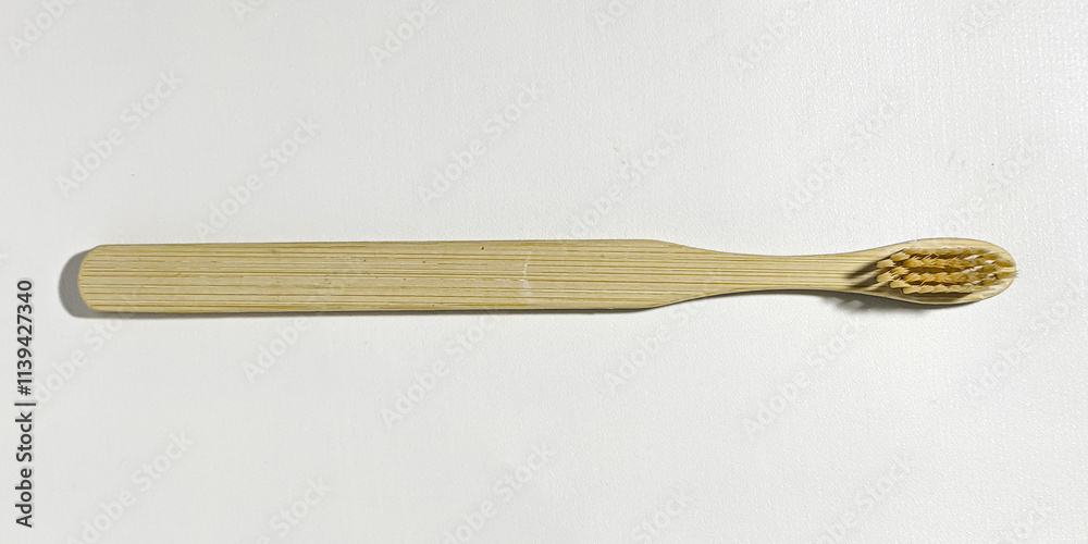 Eco-friendly dental health wooden toothbrush on a white background. Close up view in the studio. Eco-friendly dental health wooden toothbrush on a white background. Close up view in the studio.