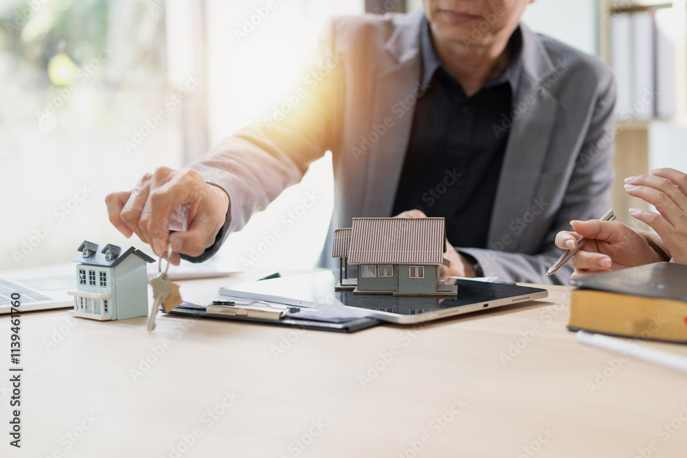 Fototapeta premium Real estate agent offering rent or buying house, Contract agreement and money, Real estate inheritance concept.