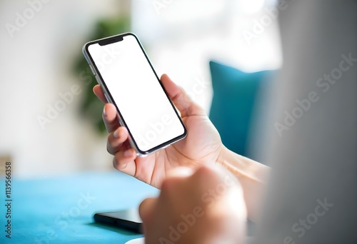 A person's hands holding a smartphone with a blank white screen
