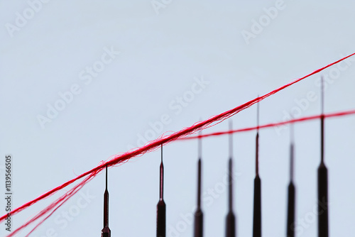 the red thread runs through several needles. business concept photo