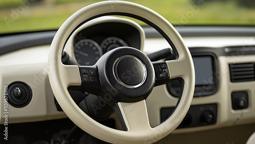 Luxury Cream-Colored Steering Wheel with Modern Controls Against Natural Background