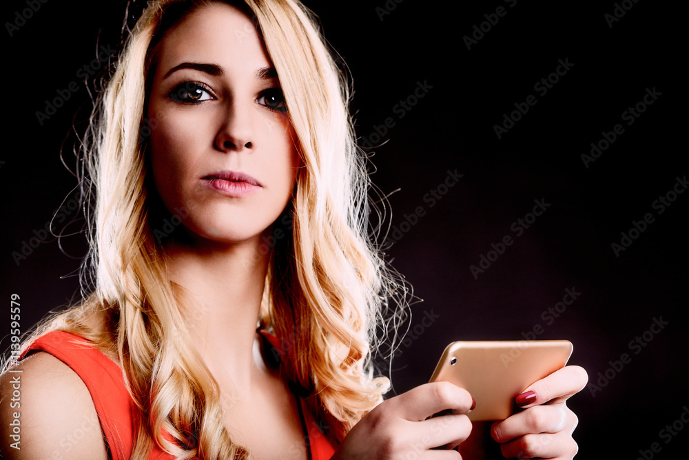 Serious young woman holding tablet computer in studio shot Serious young woman holding tablet computer in studio shot