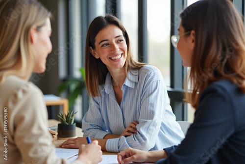 Professional Women in Business Meeting Discussing Ideas and Collaborating in Office Setting photo