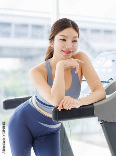 Asian young beautiful cheerful woman, active sport girl in sportswear exercise standing pose at treadmill training in fitness gym or living room smiling look at camera health care wellness lifestyle. Free Download Asian young beautiful cheerful woman, active sport girl in sportswear exercise standing pose at treadmill training in fitness gym or living room smiling look at camera health care wellness lifestyle. - GFXLoad