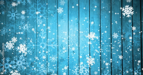 Image of snow falling on blue wooden background with copy space at christmas photo