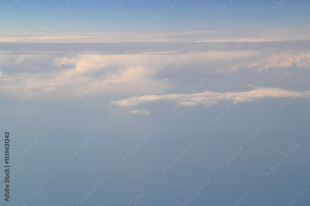 Photo of the gradient blue sky with white clouds from the porthole of the plane Photo of the gradient blue sky with white clouds from the porthole of the plane