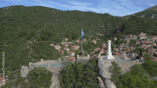 A drone captures the stunning view of the monument on the front hill, with the traditional village of Stemnitsa revealed in the background, nestled among lush greenery and timeless charm photo