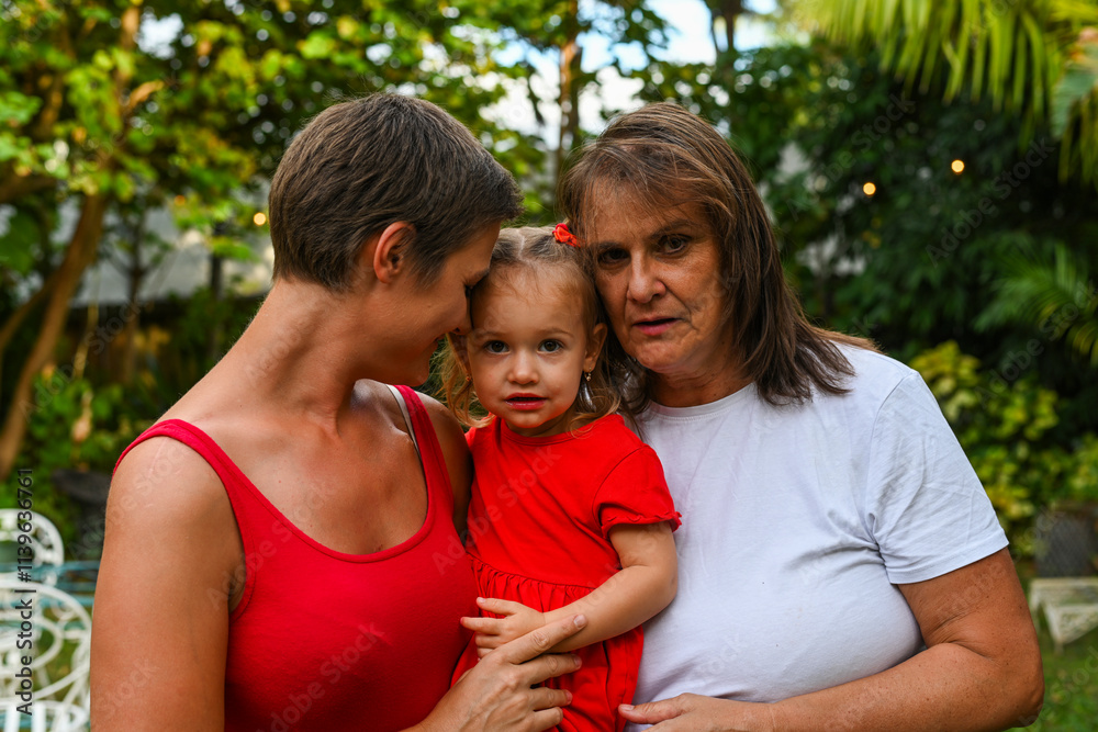 Three generations embrace in backyard Three generations embrace in backyard
