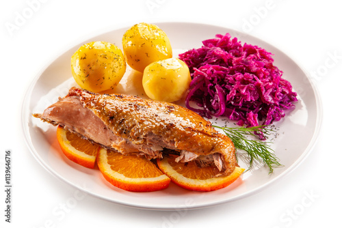Roast duck breast with boiled potatoes and pickled red cabbage on white background