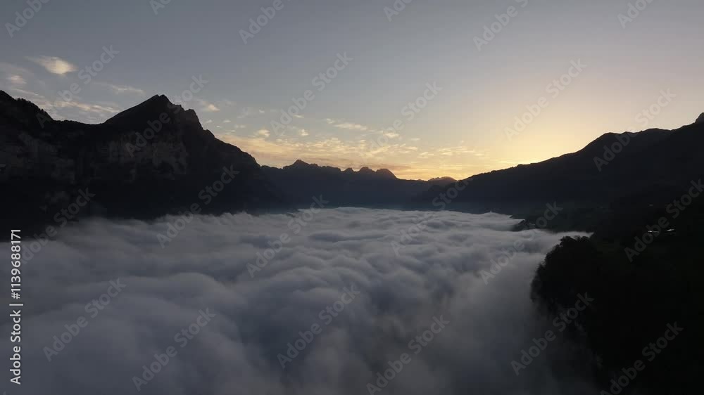 Aerial view above soft, fluffy clouds with majestic Swiss alps surrounding Walensee, Amden, Switzerland. Aerial view above soft, fluffy clouds with majestic Swiss alps surrounding Walensee, Amden, Switzerland.