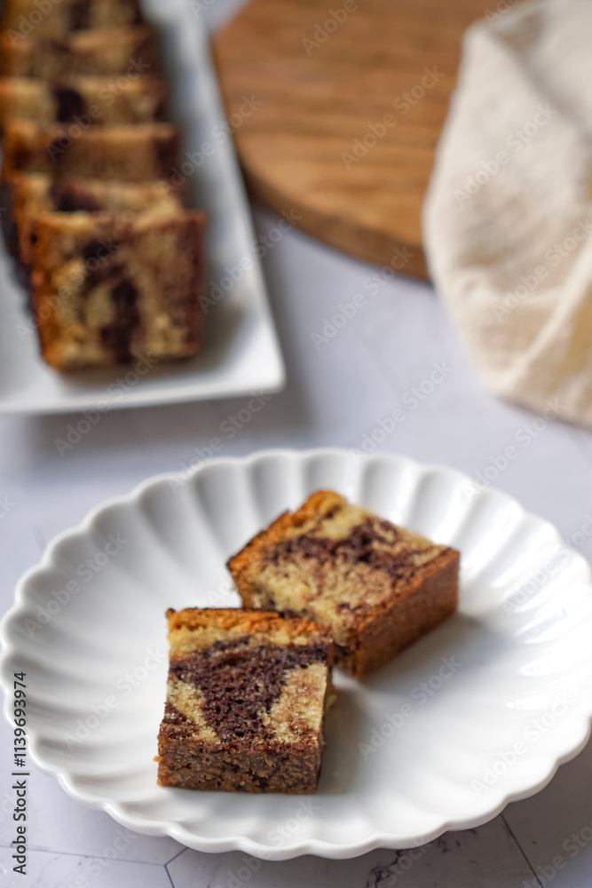 Slices of marble cake on white plates Slices of marble cake on white plates