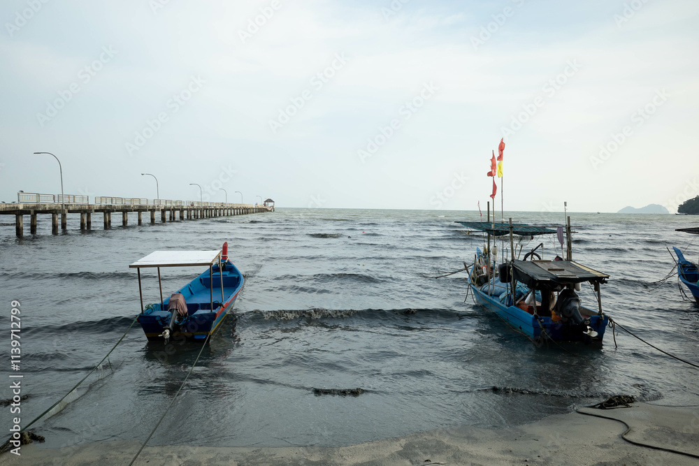 Obraz premium Anchored small Malaysian fisherman boats riding the waves in the afternoon