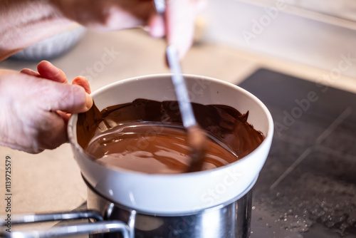 Stockholm, Sweden Chocolate melts over a steam bath on the stove for baking.