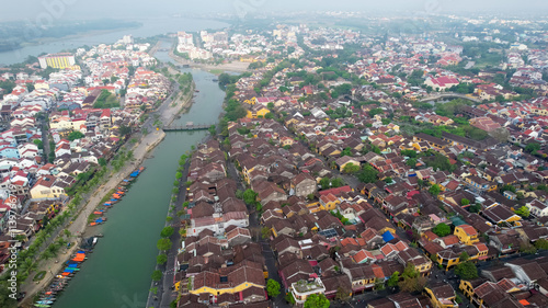 Aerial view of Hoi An, Vietnam, showcasing historic architecture along the Thu Bon River, ideal for cultural tourism and travel concepts