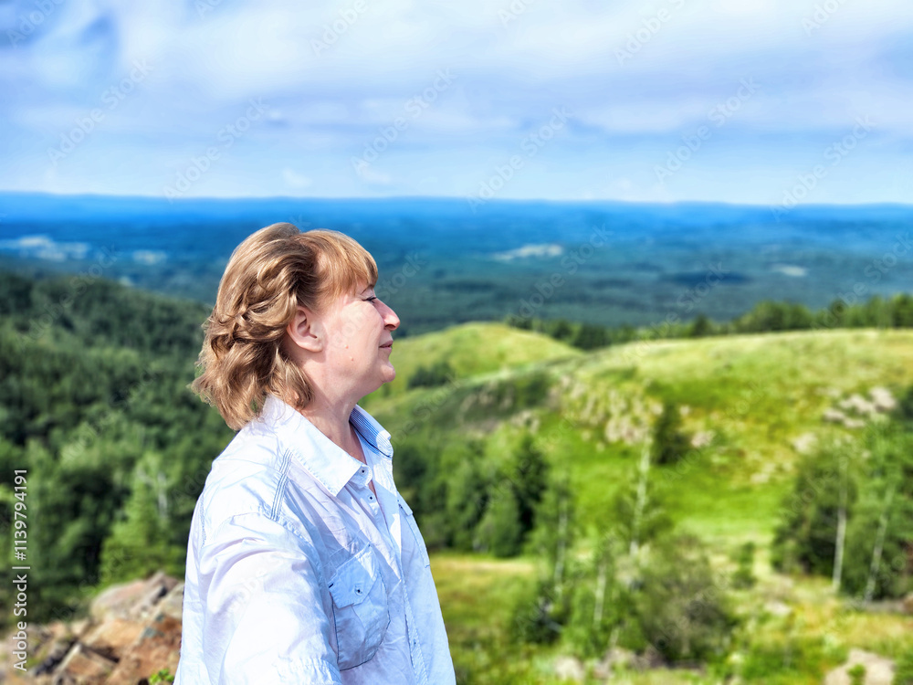 Adventures on a journey. A blogger poses, takes a selfie or podcast in the mountains with a magnificent view Adventures on a journey. A blogger poses, takes a selfie or podcast in the mountains with a magnificent view