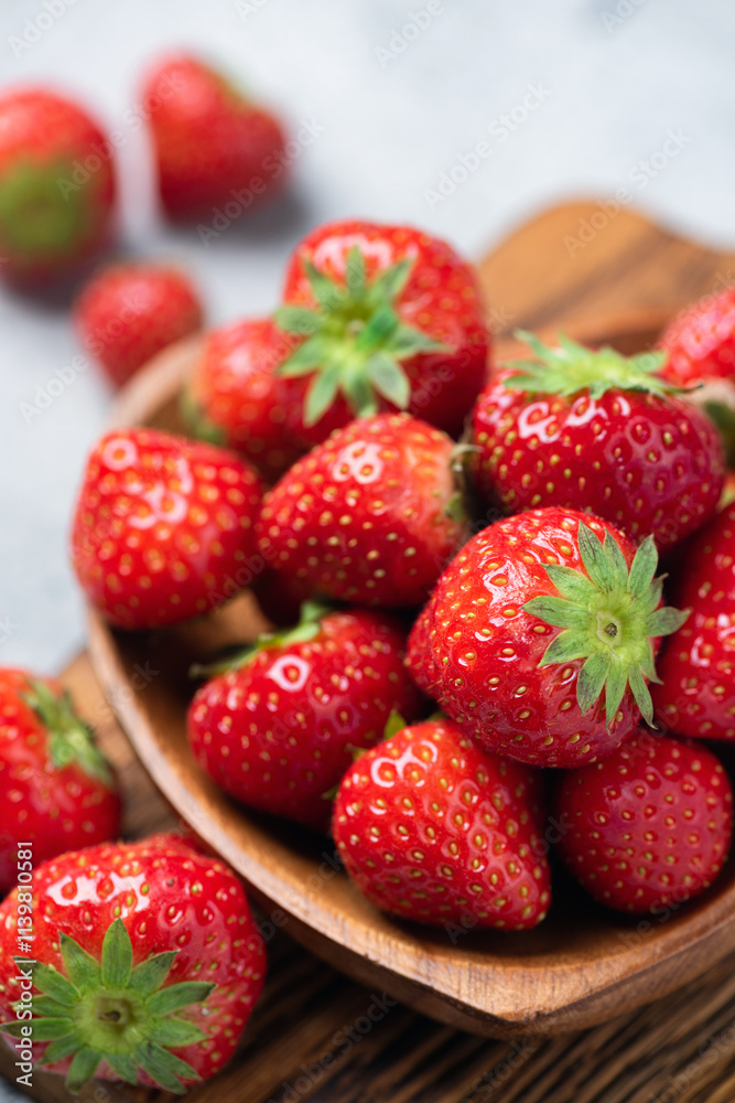 Fresh juicy strawberries in wooden bowl closeup view, seasonal summer berry fruits rich in vitamin C Fresh juicy strawberries in wooden bowl closeup view, seasonal summer berry fruits rich in vitamin C
