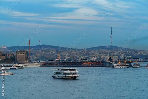 view of the Galata Bridge and ships on the Bosphorus, the cityscape of Istanbul, Turkey, the architecture of the city at sunset, a popular tourist destination.