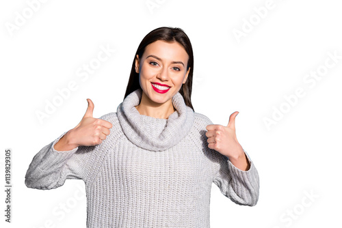 Portrait of charming youth showing thumb up promotion wearing gray pullover isolated over blue background