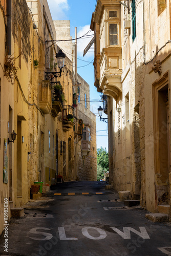 Fototapeta Naklejka Na Ścianę i Meble -  a beautiful iconic cityscape view through the small and the narrow streets of Mdina, Malta. With lots of power cables 