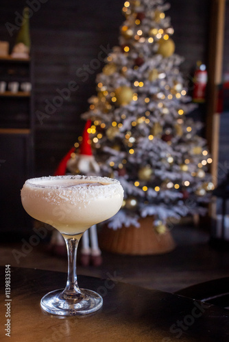 Coconut Cocktail with Dried Coconut Pieces Against a Blurred Background of a New Year’s Tree