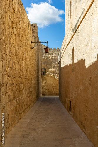 Fototapeta Naklejka Na Ścianę i Meble -  a beautiful iconic cityscape view through the small and the narrow streets of Mdina, Malta. 