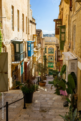 Fototapeta Naklejka Na Ścianę i Meble -  beautiful cityscape view in the small streets of the historic Valetta, Malta. With lots of colorful house facades, balconies and decoration