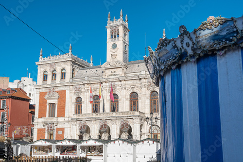 Ayuntamiento y plaza mayor de Valladolid con carrusel y mercadillo para navidad durante el mes de diciembre, España photo