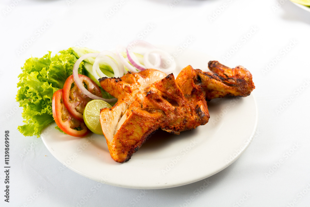 grilled chickens tikka with lemon, union, tomato and chilly powder. grilled chickens tikka with lemon, union, tomato and chilly powder.