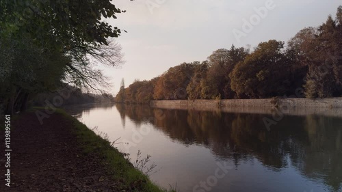 Static view of the tree-lined Cher River in France’s Loire Valley at dusk