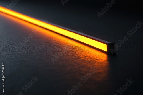 A sleek, modern LED light bar emits a warm, amber glow on a dark surface.