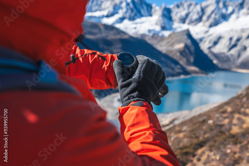 Backpacking woman checking the elevation on sports watch on high altitude mountain top photo