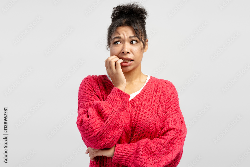 Worried young woman biting her nails on white background Worried young woman biting her nails on white background