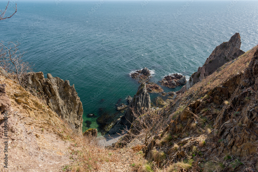View of the vastness of the Pacific Ocean from the high seashore. High cliffs on the shore of the Pacific Ocean. View of the vastness of the Pacific Ocean from the high seashore. High cliffs on the shore of the Pacific Ocean.