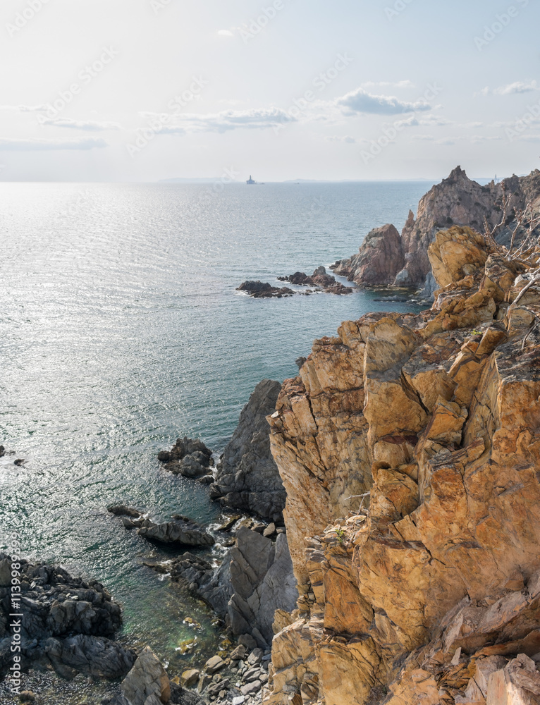 View of the vastness of the Pacific Ocean from the high seashore. High cliffs on the shore of the Pacific Ocean.