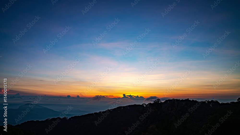 The sun sets behind a dense forest, casting a golden glow through billowing clouds and mist. This captivating scene blends warm and cool tones, creating a dramatic and serene natural landscape.
The sun sets behind a dense forest, casting a golden glow through billowing clouds and mist. This captivating scene blends warm and cool tones, creating a dramatic and serene natural landscape.