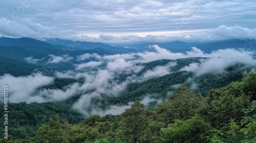 Majestic mountain landscape framed by dramatic clouds and mist creating a serene and tranquil atmosphere in nature.