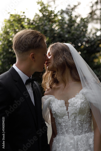 A Beautiful and Romantic Wedding Couple Posing Together in an Elegant Garden Setting